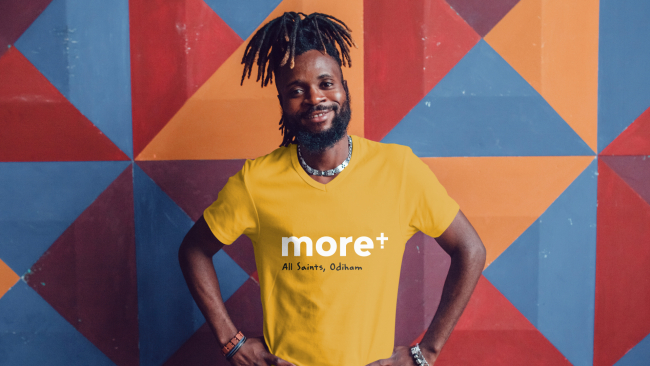 Man smiling with More t-shirt on